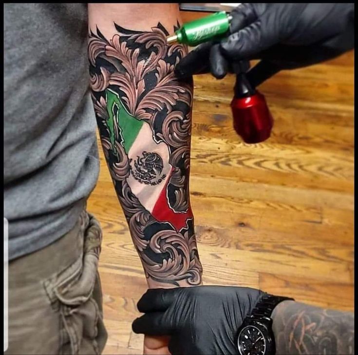 a man with a tattoo on his arm is getting inked by another person in black gloves