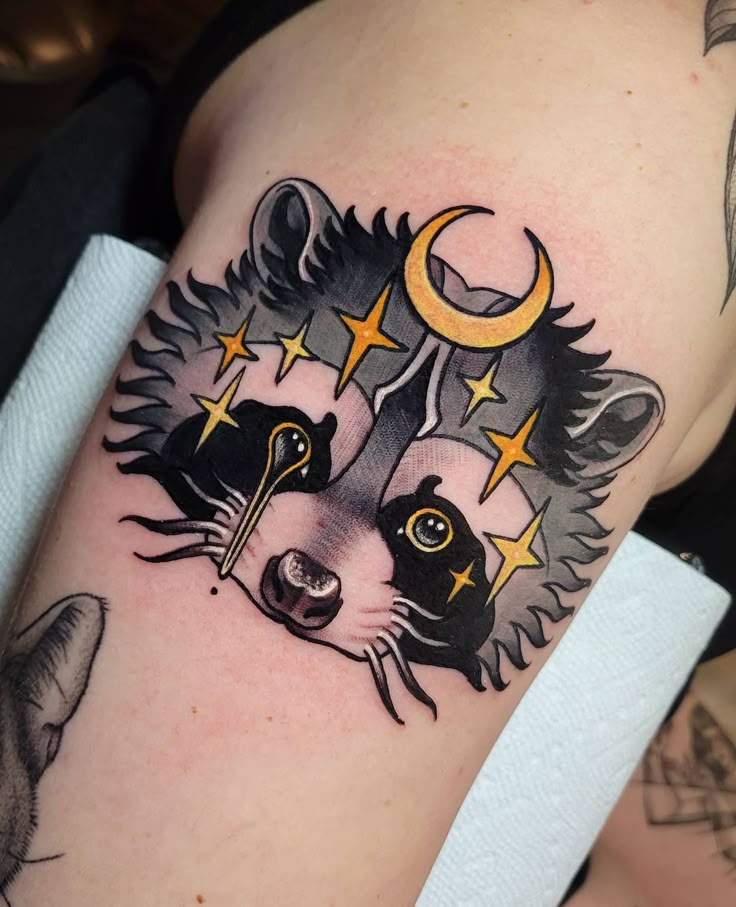 a raccoon with stars and moon on its head is shown in this tattoo design