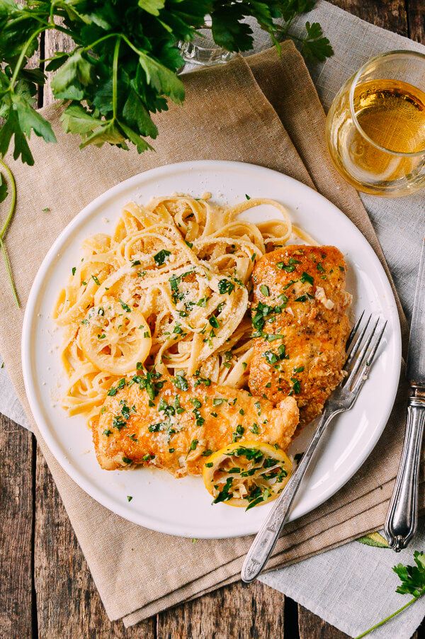 a white plate topped with chicken and pasta