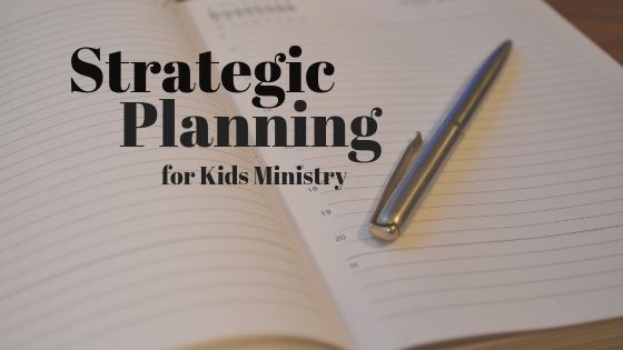 an open notebook with a pen on top of it and the words strategy planning for kids ministry