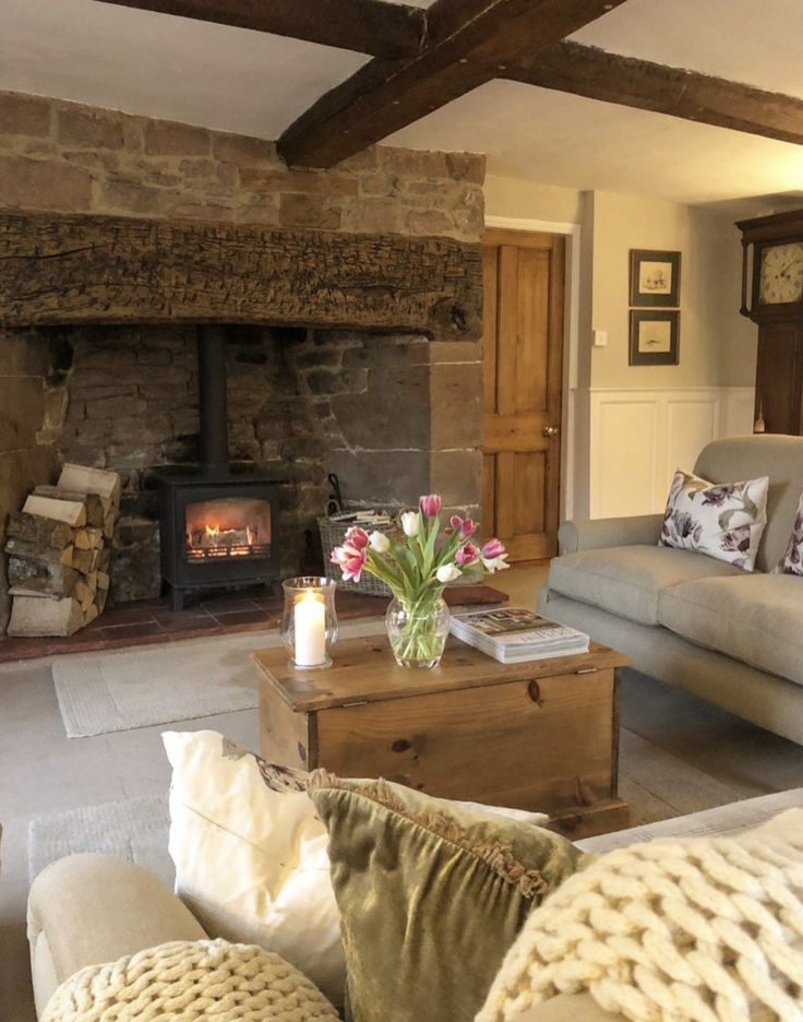 a living room filled with furniture and a fire place in the middle of it's walls