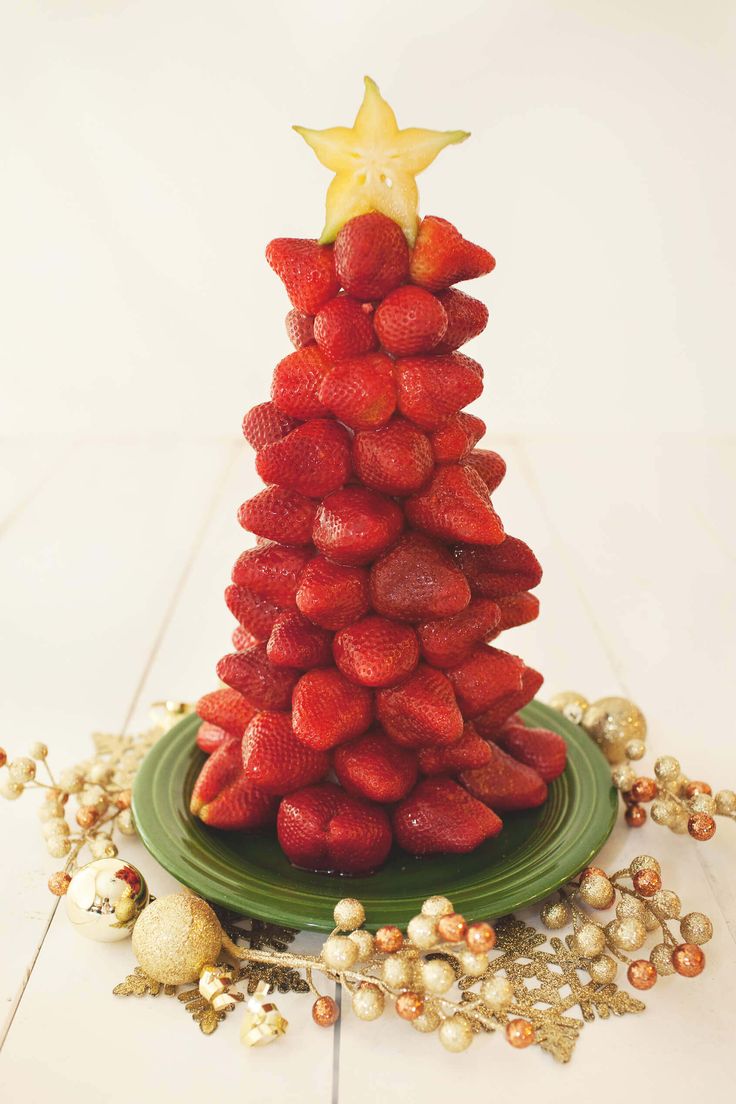 a christmas tree made out of strawberries with a star on top