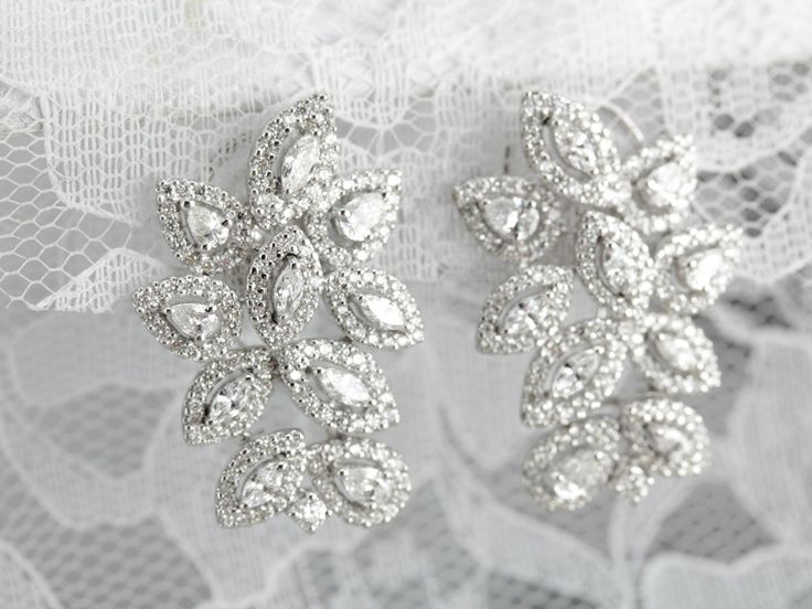 These vintage cocktail earrings are beautifully crafted, substantial and luxurious in style! Bright white gold forms a gleaming frame for the outstanding diamonds that form a glittering motif, sure to be an heirloom piece for years to come! Metal: 18K White Gold Gem: 326 Diamonds totaling totaling 4.55 Carats Earrings Length: 30 mm Earrings Width: 19 mm Glamorous Bridal Earrings, Diamond With Brilliant Cut, Glamorous Diamond Bridal Earrings With Brilliant Cut, Glamorous Brilliant Cut Diamond White Earrings, Glamorous Diamond Earrings With Sparkling Stones For Wedding, Glamorous Diamond Earrings For Wedding, Glamorous Diamond Earrings For Anniversary, Glamorous Diamond Wedding Earrings, Glamorous Formal Diamond Bridal Earrings, Glamorous White Gold Bridal Earrings