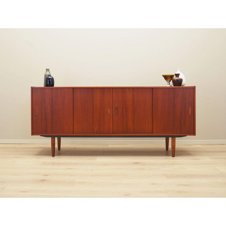 a sideboard with two vases on top of it