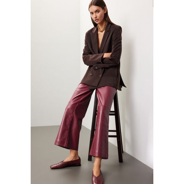 Red faux leather (100% Polyurethane faux leather). Pants. Front zipper closure. 28" inseam. 11.5" rise. Imported. Fall Wide Leg Faux Leather Pants, Sleek Leather Bottoms For Fall, Trendy Leather Bottoms For Fall, Faux Leather Wide-leg Pants For Fall, Fall Wide-leg Faux Leather Pants, Sleek Wide-leg Leather Pants For Fall, Fall Leather Straight Pants, Trendy Leather Straight Pants For Fall, Fall Brown Wide-leg Leather Pants