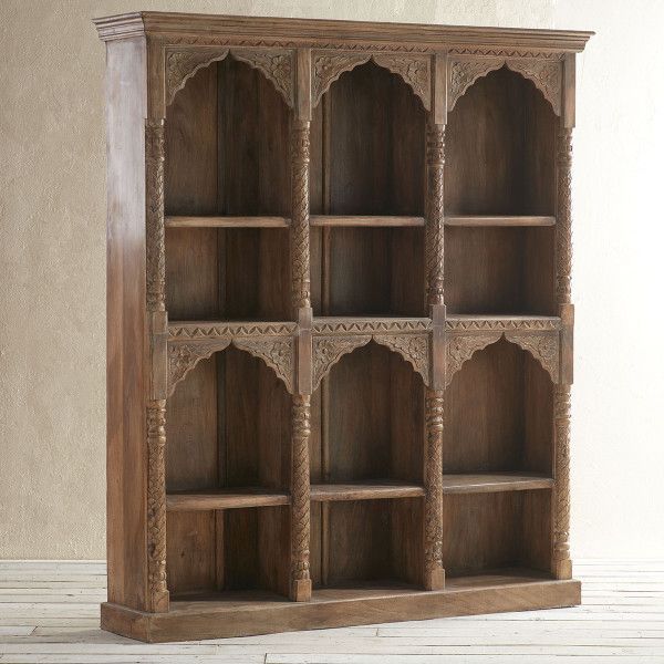 an old wooden bookcase with carved details