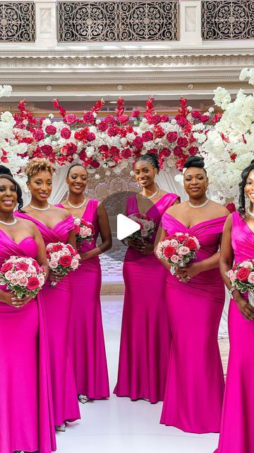 a group of women in pink dresses standing next to each other