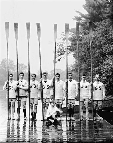 a group of men standing next to each other on top of a river