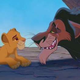 the lion king and cub lying down in front of each other with their mouths open