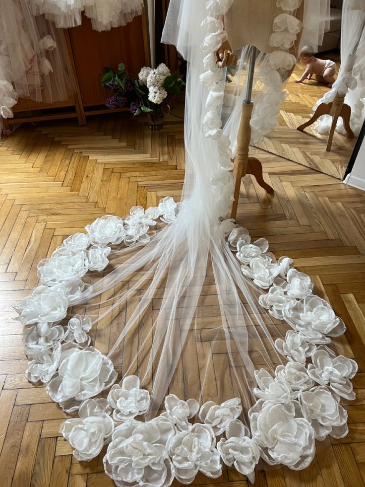 the wedding dress is covered with white flowers