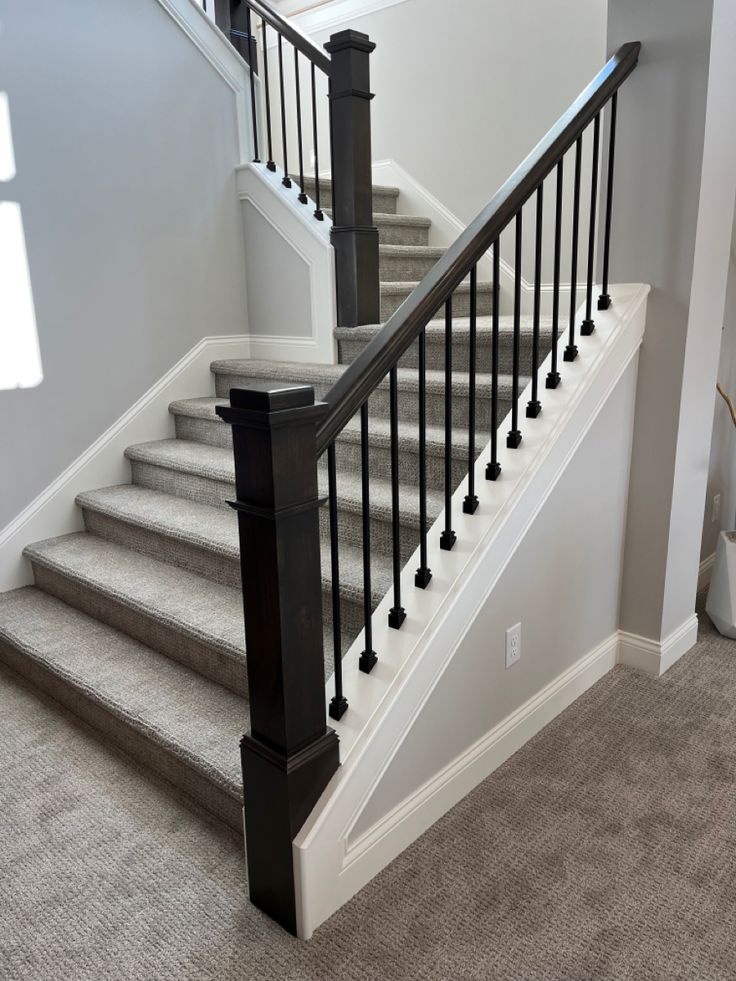 the stairs in this house have black railings