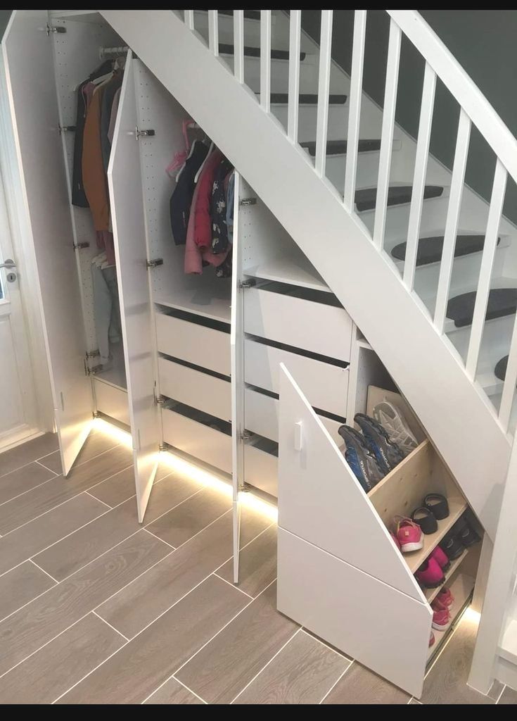 an open closet under a stair case