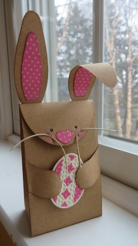 a brown paper bag with pink polka dots on it and a bunny in the pocket