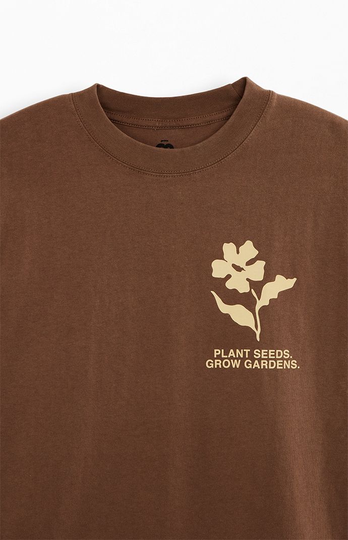 The Garden & Seeds Mission Co-Op T-Shirt blends timeless design with a distinct touch. This tee features a crew neckline, short sleeves, a standard fit, and a vintage wash, complemented by custom branding on both the front and back, making it a versatile and stylish addition to your collection.   	Crew neckline 	Short sleeves 	Standard fit 	Vintage wash 	Front & back graphics 	Machine washable Monochromatic T Shirt Design, Random Tshirt Designs, Made In The 90s Shirt, Corporate Tee Shirt Design, Earthy Graphic Tees, Farm Inspired Outfits, T Shirt Collage Design, Minimal Apparel Design, Graphic Tee Back Design