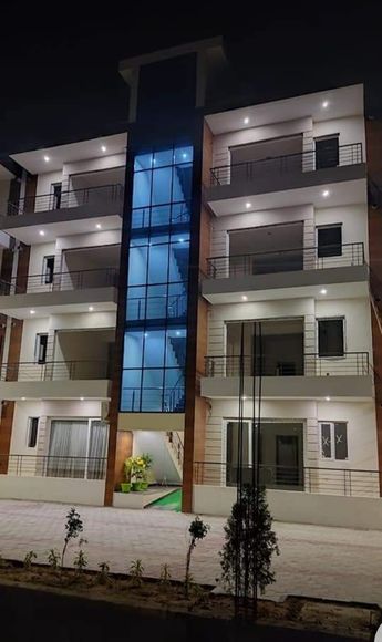 an apartment building lit up at night