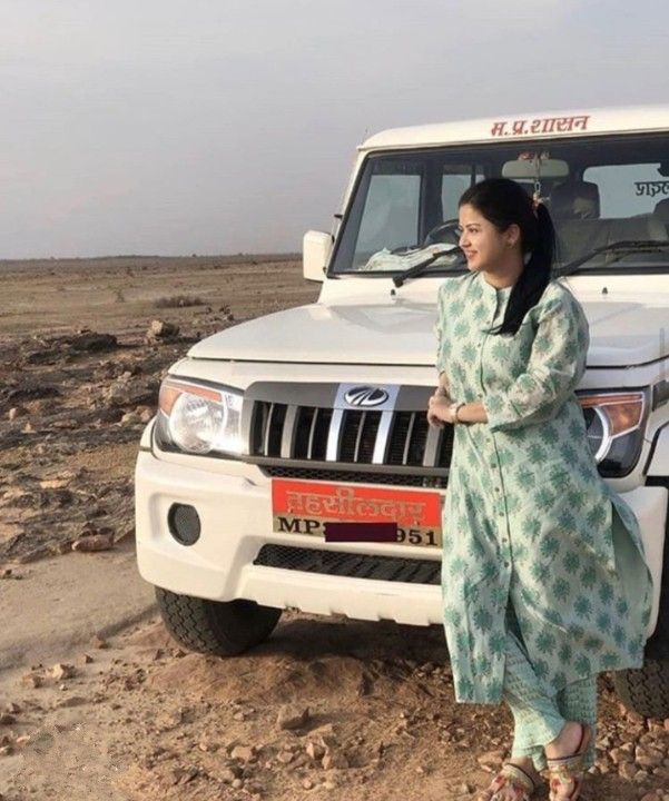 a woman standing in front of a white truck