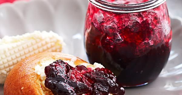 jelly and corn on the cob with jam in a glass jar next to it