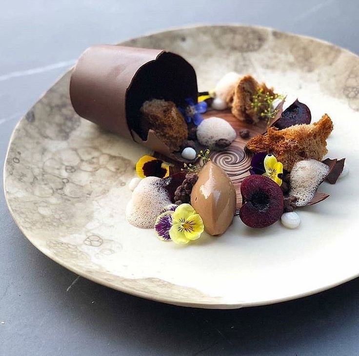 a white plate topped with dessert and flowers