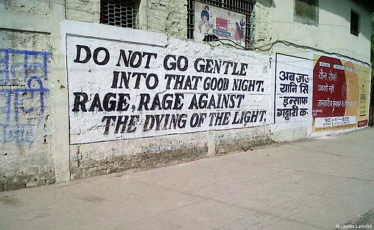 black and white photograph of graffiti on the side of a building with words written on it