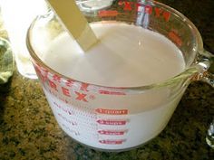 a measuring cup filled with milk on top of a counter