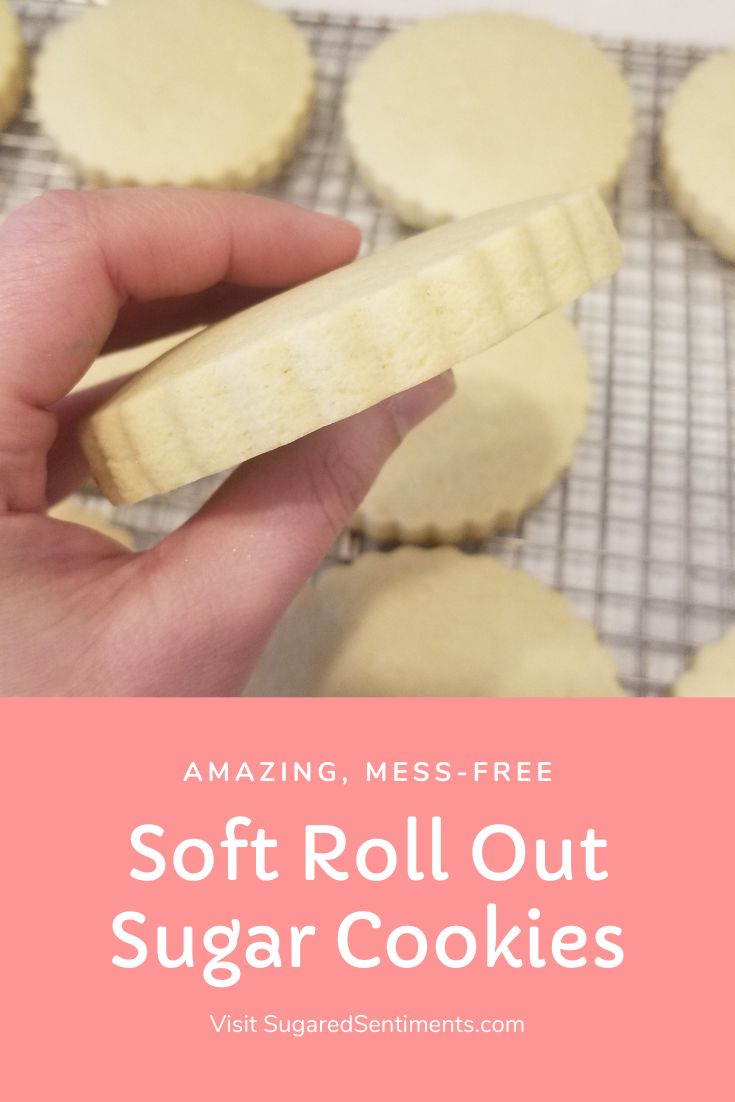 a person holding a wooden spoon over some sugar cookies on a cooling rack with the words, amazing mess - free soft roll out sugar cookies