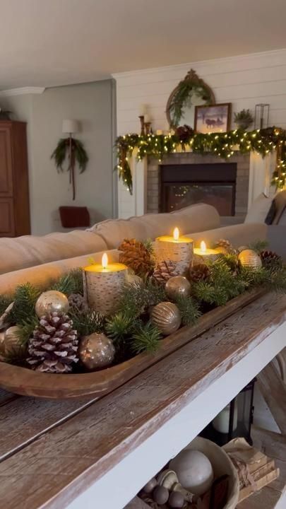 a tray filled with candles sitting on top of a wooden table next to a couch