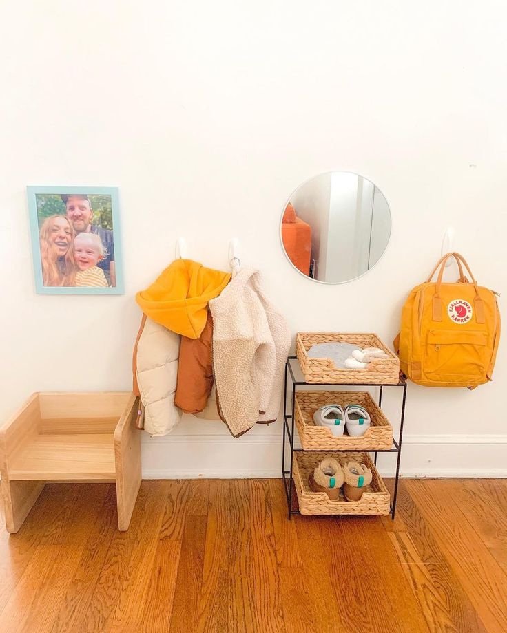 there is a mirror and some shoes on the floor in this room with white walls