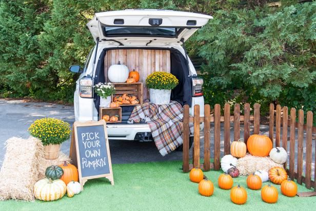 an open van with pumpkins and hay in the back