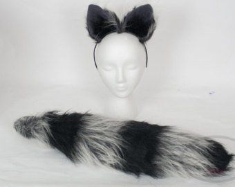 a white mannequin head with black and grey fur