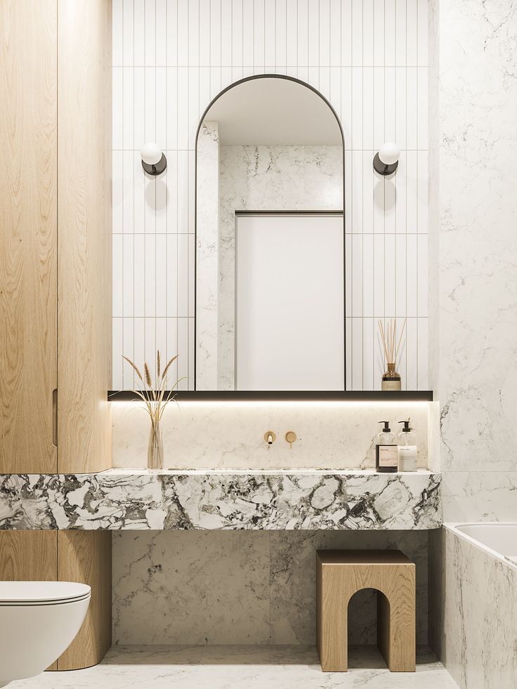 a bathroom with marble counter tops and white walls