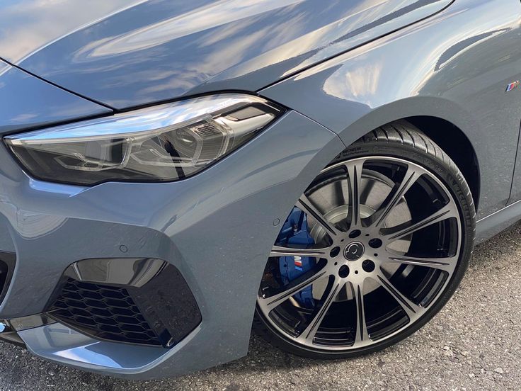 the front end of a grey bmw car