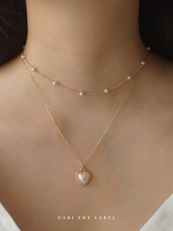 Trendy Gold Charm Necklace With Pearl Chain, Gold Delicate Chain Pearl Choker, Gold Pearl Choker With Delicate Chain, Gold Pearl Choker Necklace With Delicate Chain, Trendy Gold Pearl Charm Necklaces, Gold Heart-shaped Pearl Clavicle Necklace, Dainty Pearl Pendant Necklace With Delicate Chain, Gold Layered Necklace With Pearl Drop For Gift, Dainty Gold Heart-shaped Pearl Necklace