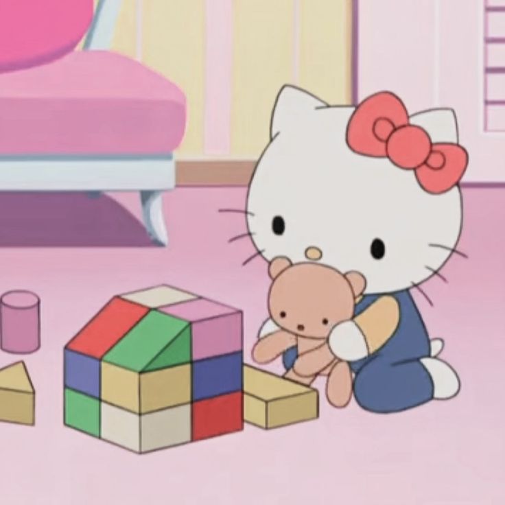 hello kitty playing with blocks and toys in her bedroom on the pink carpeted floor