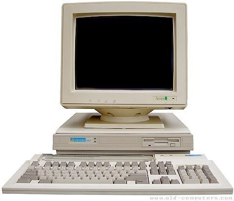 an old computer sitting on top of a desk with a keyboard and mouse in front of it