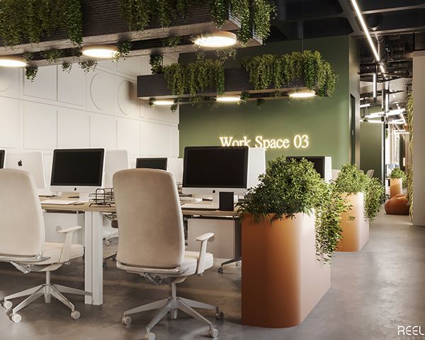 an office with many computers and plants on the desks in front of them,