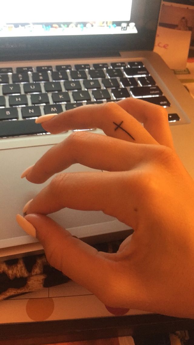 two hands on top of a laptop keyboard with one hand holding the other's finger