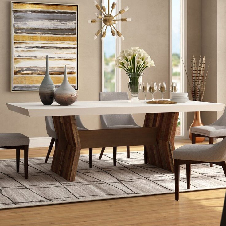 a dining room table with chairs and vases on it