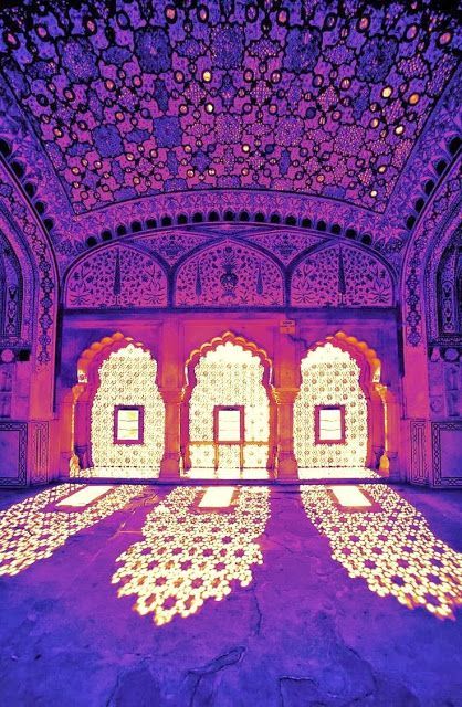 an intricately decorated room with purple lighting