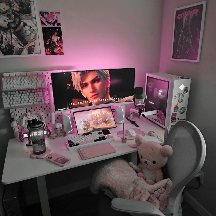 a computer desk topped with a monitor and a teddy bear