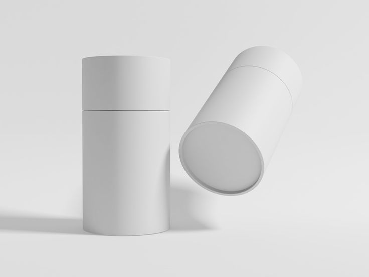 two white cylindrical objects on a plain surface