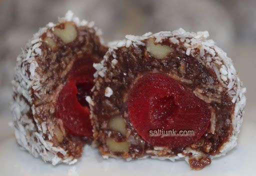 two pieces of chocolate covered with fruit and nuts