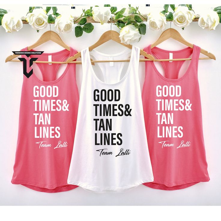 three women's tank tops hanging on a rack with white roses in the background