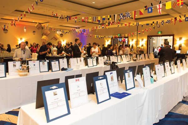 many people are standing around tables with plaques on them