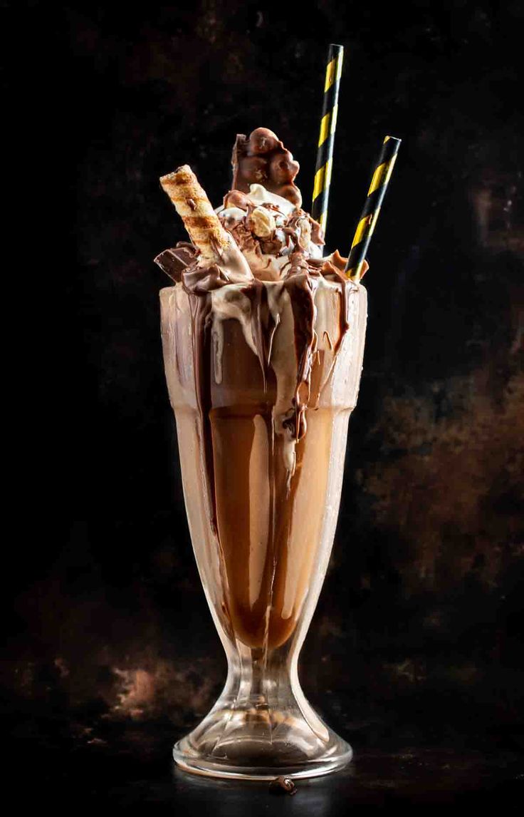 an ice cream sundae in a glass with chocolate and marshmallows