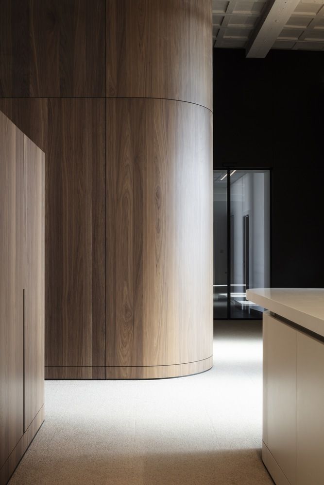 an empty room with wooden walls and white counter tops