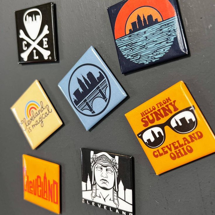 several badges on a refrigerator door that say hello from sunny cleveland, hell city and oakland