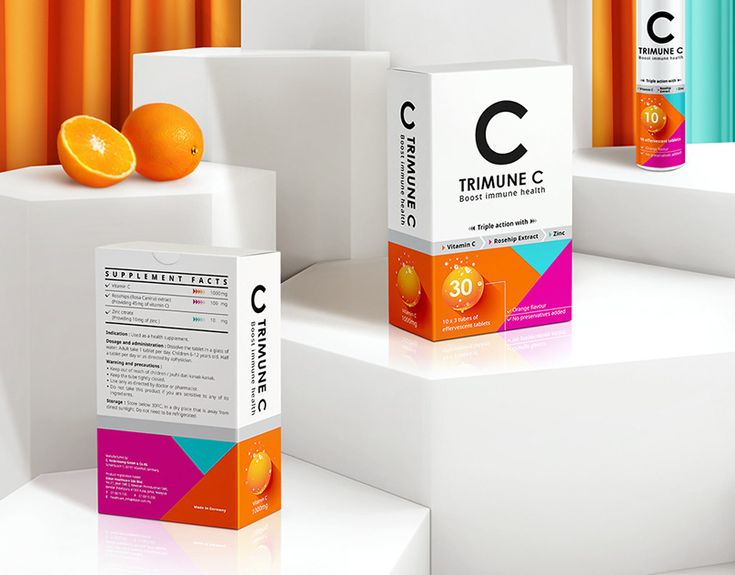 three oranges sitting on top of white boxes with the letter c in front of them