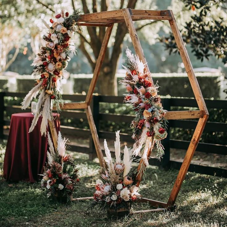 an outdoor ceremony setup with flowers and feathers