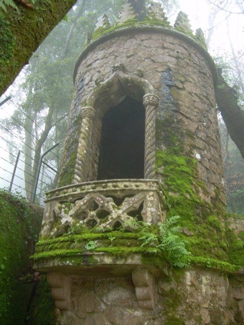 an old stone tower with moss growing on it