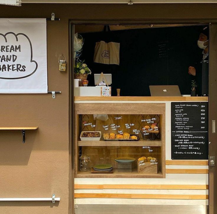 a bakery with an open door and sign on the wall